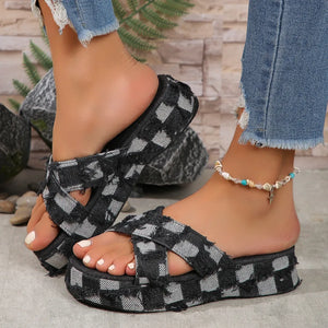 Distressed denim checkered platform slides in black with crisscross straps.