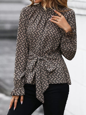 Tied ruffled flounce sleeve blouse in khaki with a geometric pattern and tie waist.
