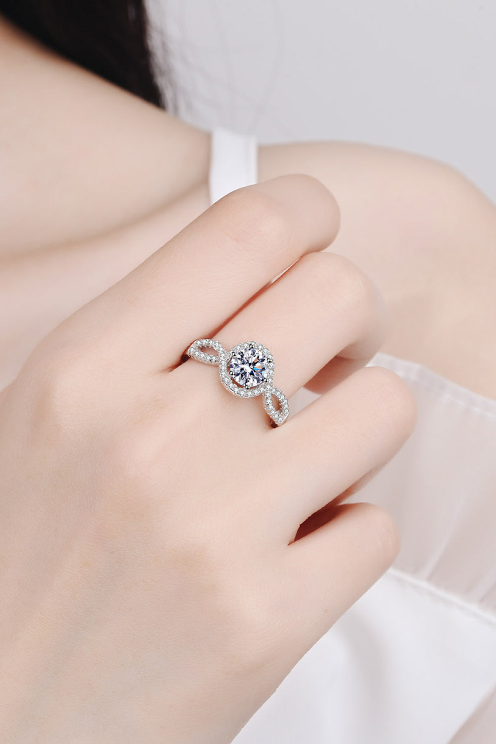 Silver infinity halo moissanite engagement ring in 925 sterling silver.
