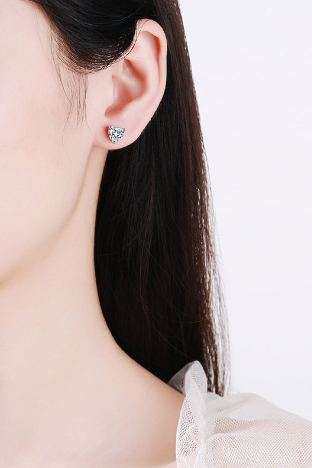 Silver heart-cut moissanite stud earrings with a classic prong setting.