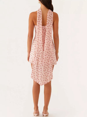 Blush pink cherry print strapless mini dress with a handkerchief hem and tie back detail.