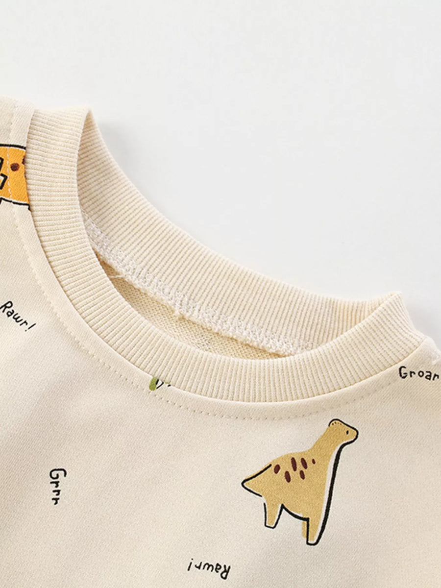 Beige cotton crew neck sweatshirt with dinosaur print and text details.