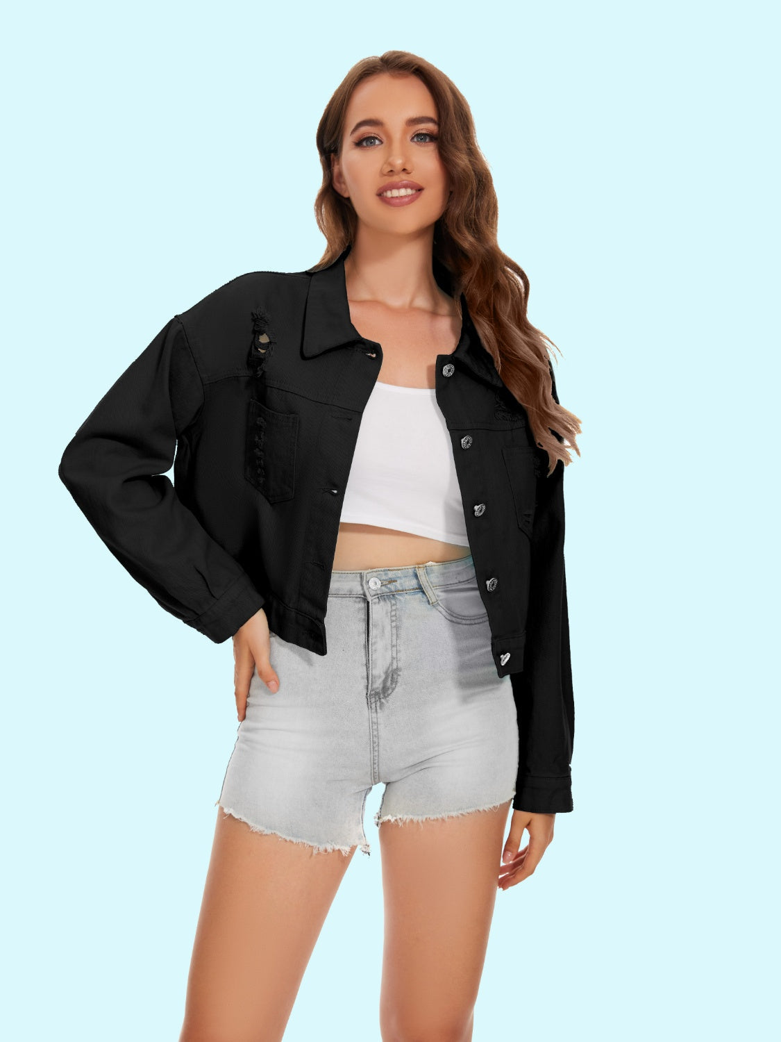 Black distressed denim trucker jacket with crystal fringe detail.