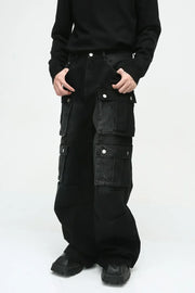 Dark cotton wide-leg cargo pants with multiple utility pockets and silver snap closures.