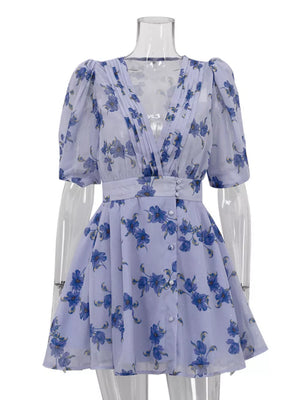 Lavender floral print mini dress with V-neck, puff sleeves, and button front.