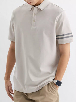 Light gray cotton polo shirt with striped sleeves and a button placket.