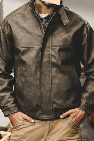 Distressed leather bomber jacket in dark gray with stand collar and elastic cuffs.