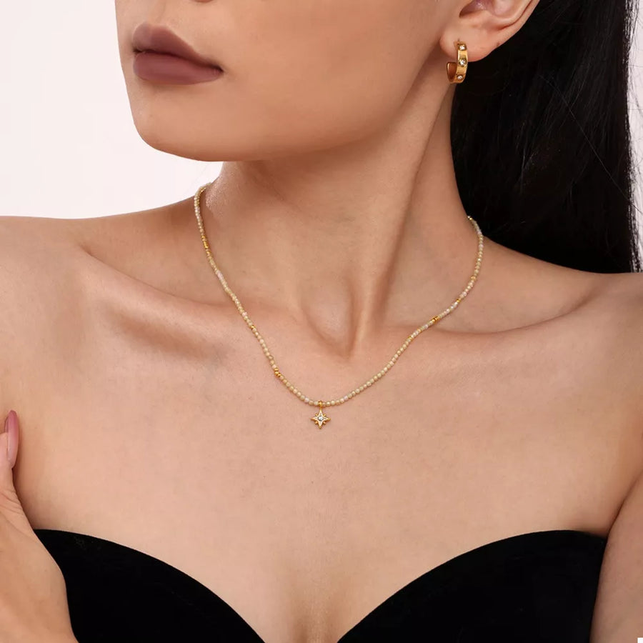 cream necklace featuring layered and star