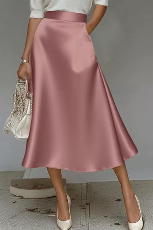 Dusty Pink satin midi skirt with a-line cut and hidden pockets, shown with a white top.