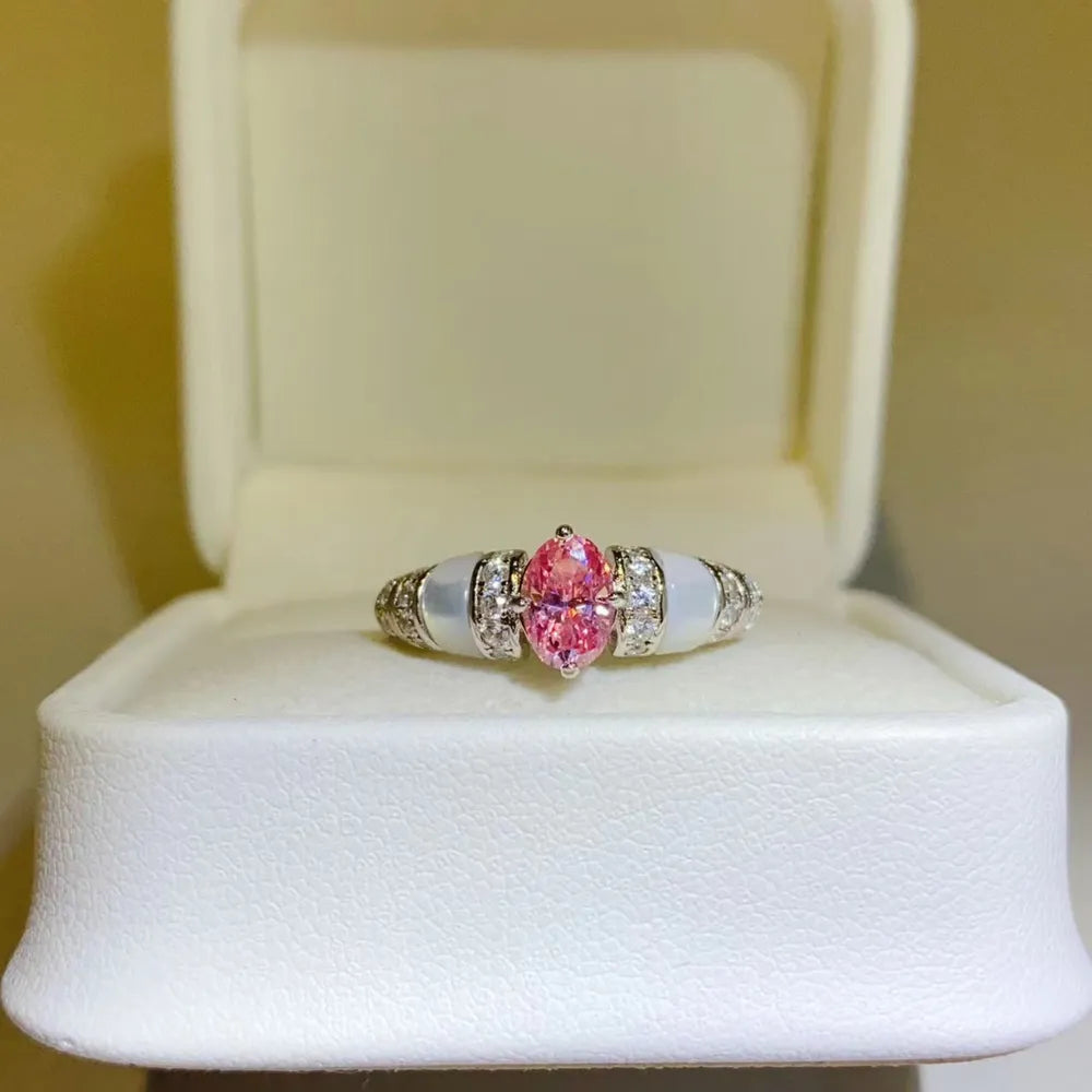 Pink oval moissanite and mother-of-pearl ring with diamond accents
