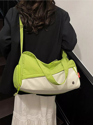 Vibrant color-block nylon travel bag with white and lime green panels and a crossbody strap.