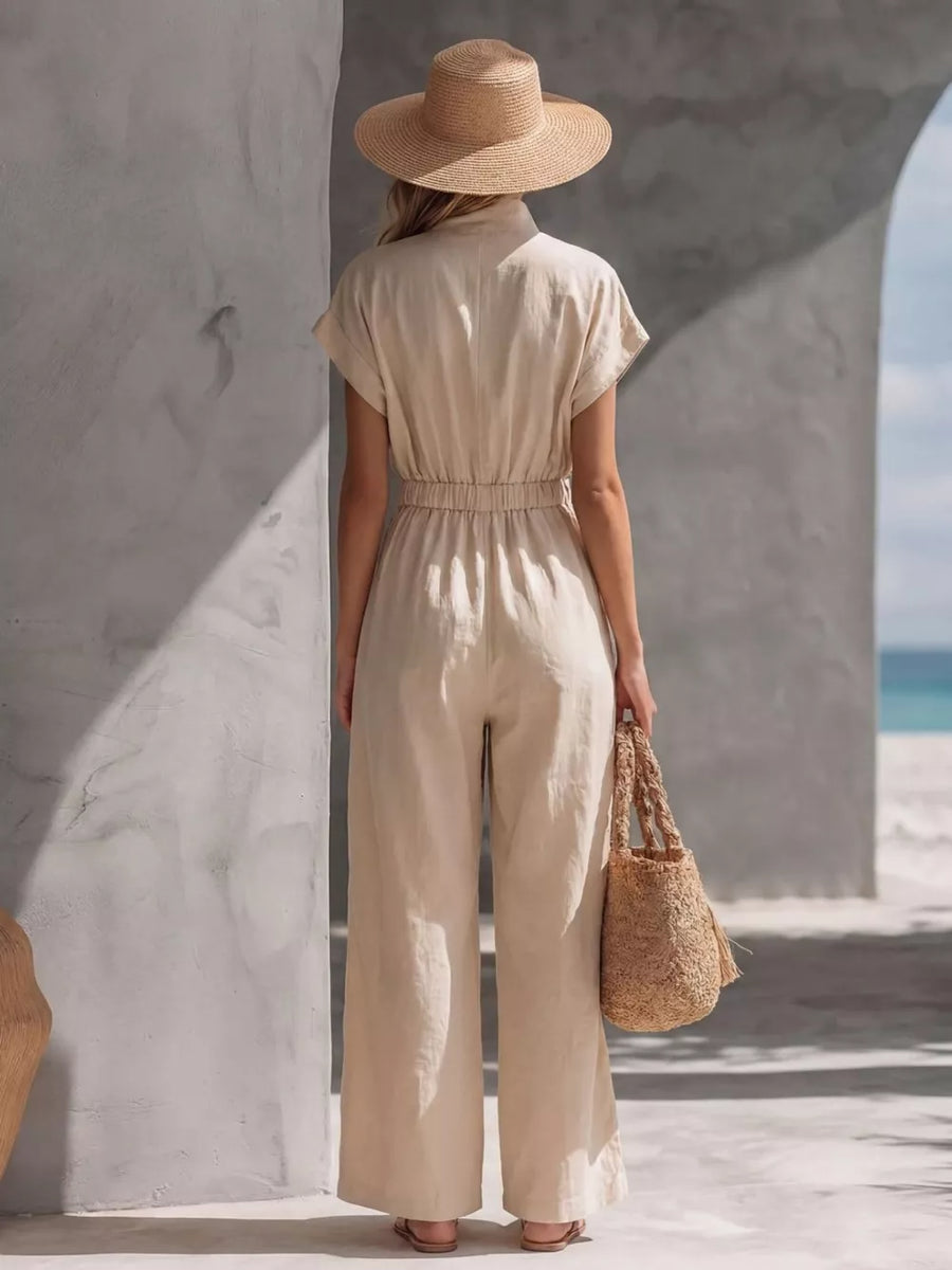 Khaki wide-leg maternity jumpsuit with short sleeves and elastic waist, shown from the back.