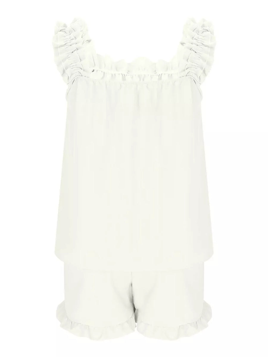 White polyester pajama set with ruffled straps and shorts.