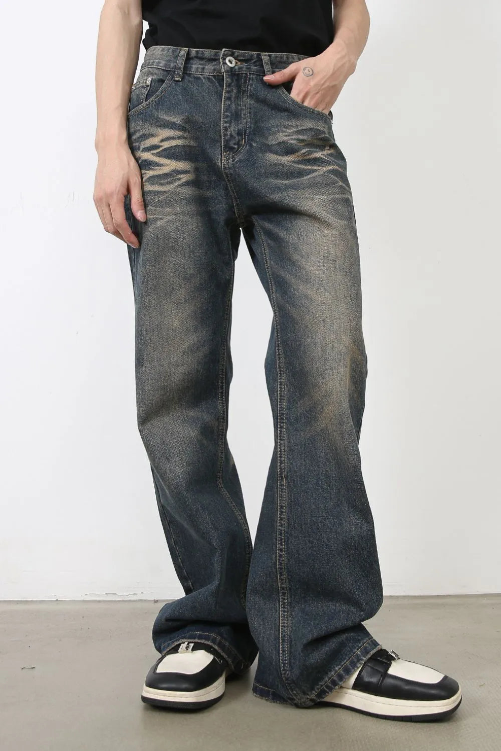 Faded wash wide-leg jeans in medium blue denim with a relaxed fit and distressed details.