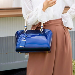 handbag in royal blue featuring top handle and structured fit