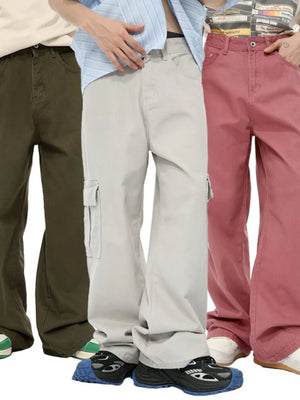 Oversized cargo denim trousers in Army Green, Eggshell, and Dusty Pink with multiple pockets.