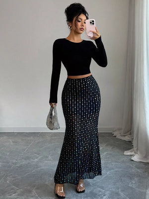 Black polka dot sheer maxi skirt with a mermaid silhouette.