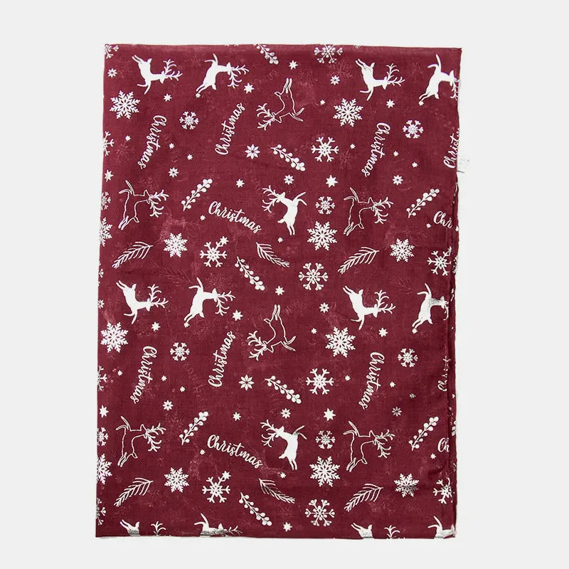 Burgundy Christmas print scarf with metallic accents and reindeer, snowflakes, and text patterns.