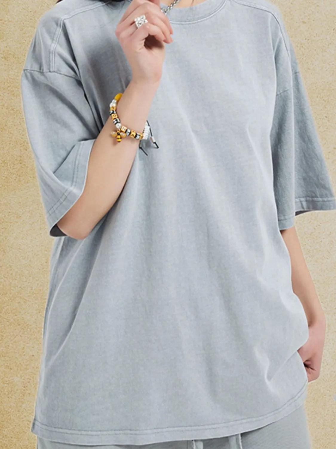 Oversized gray washed cotton tee with crew neck and short sleeves.