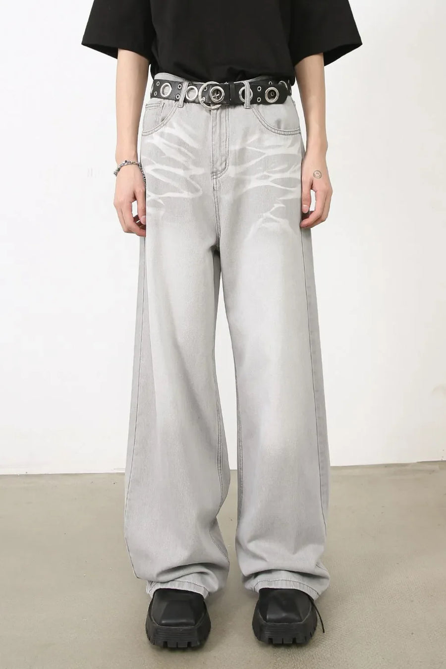Bleached wash wide-leg denim trousers in gray with a relaxed fit and distressed detailing.