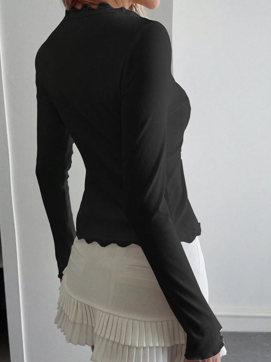 Black ribbed long sleeve top with lace trim neckline and hem