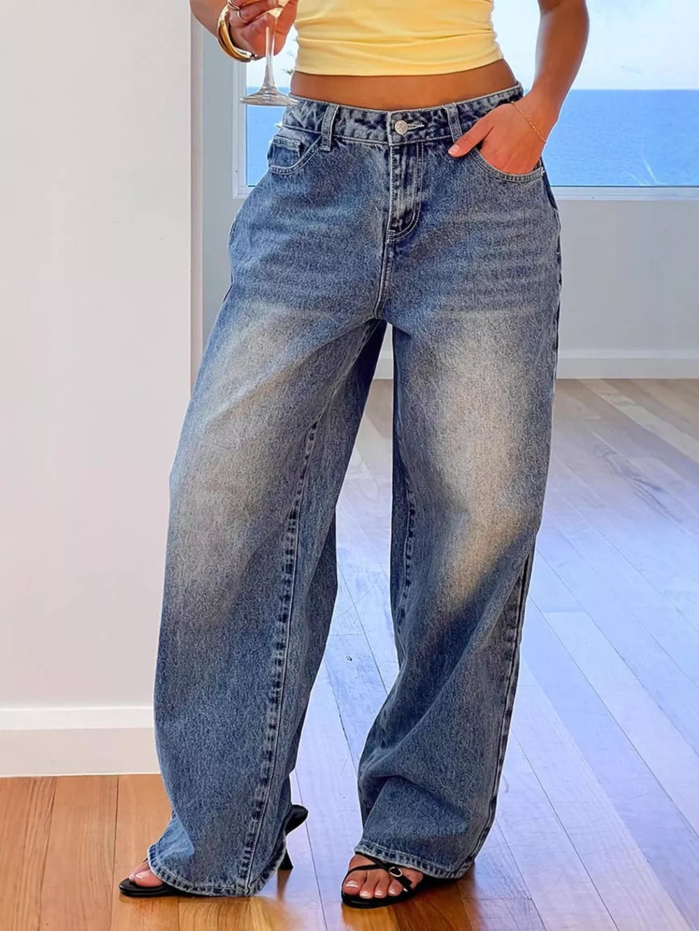 Women's blue denim wide-leg jeans with functional pockets and a relaxed fit.