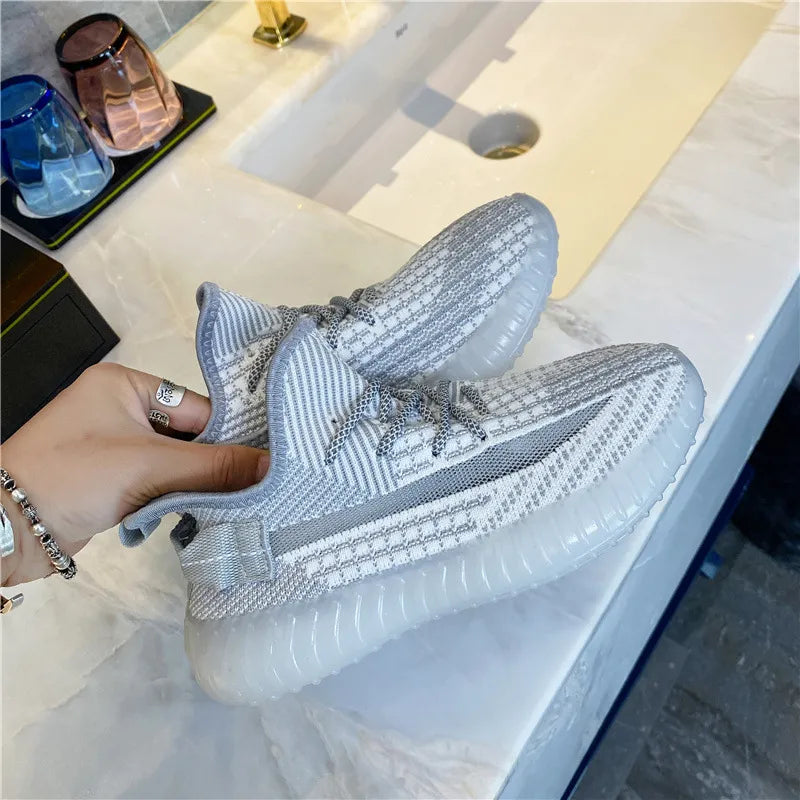 Light gray textured knit platform sneakers with white accents and clear soles.
