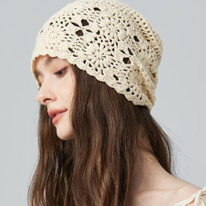 Beige crochet slouchy beanie with floral pattern and open knit detail.