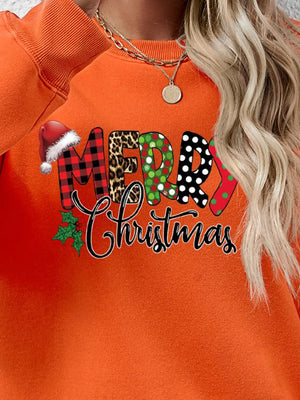 Orange graphic sweatshirt with Merry Christmas text in festive patterns and Santa hat detail.
