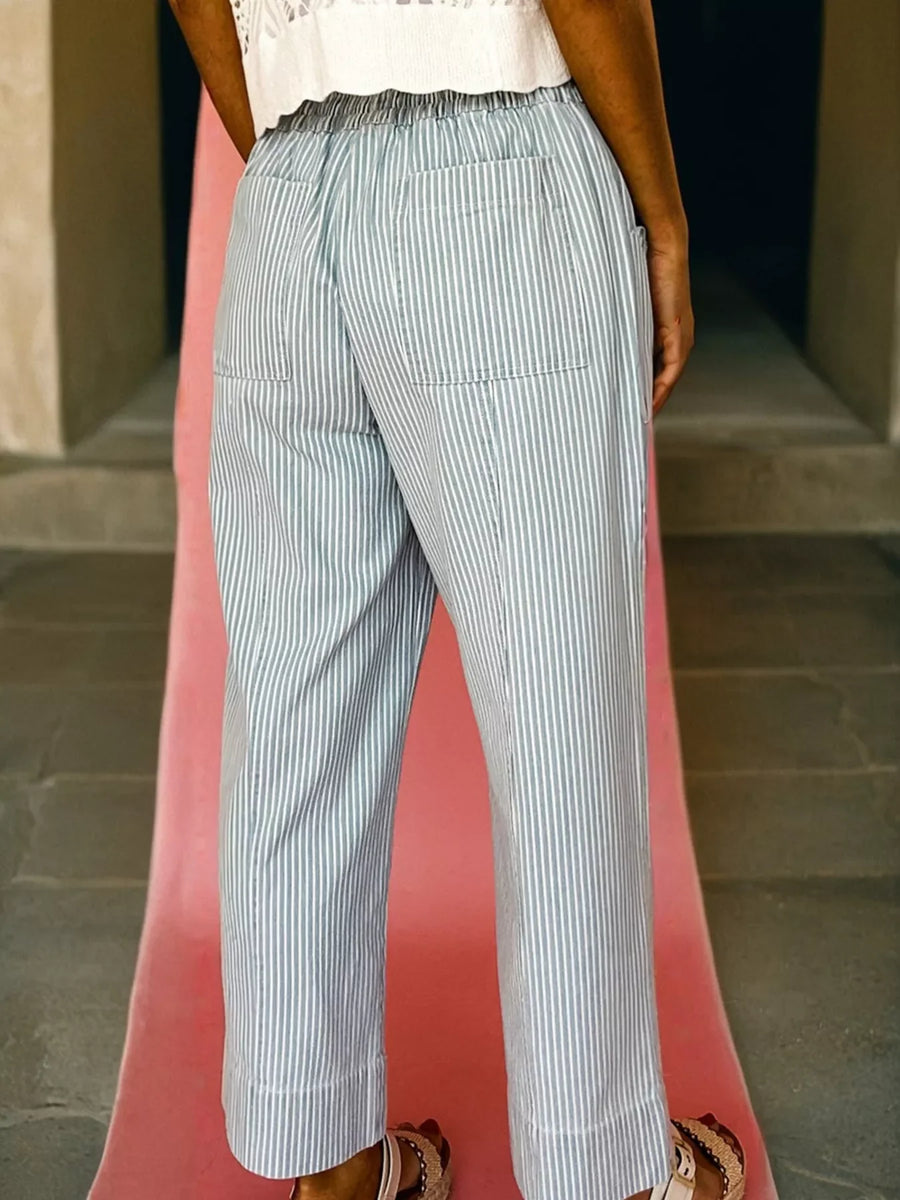 Mid rise drawstring jeans in light blue with white pinstripes and back pockets.