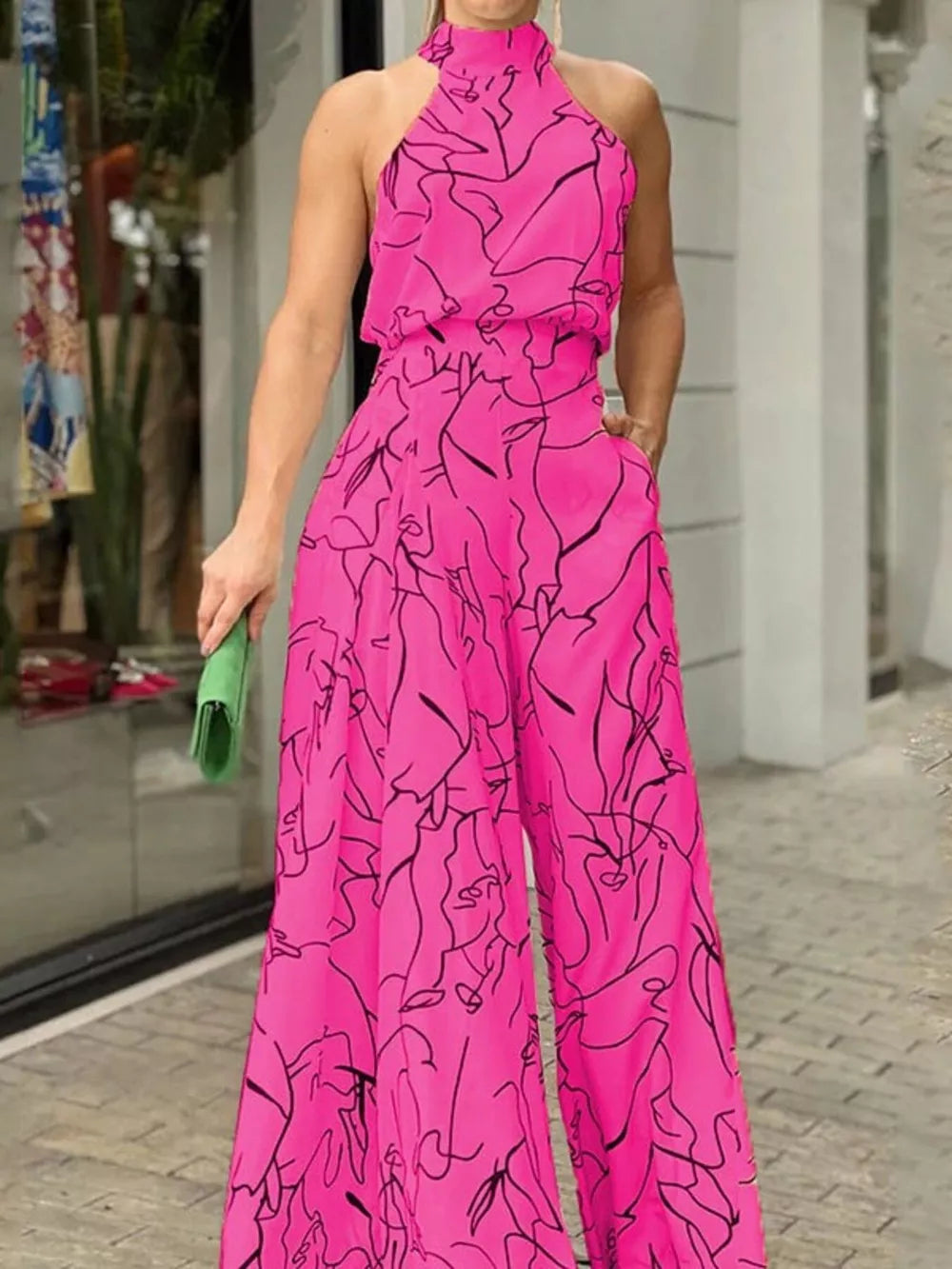 Hot Pink abstract print halter neck wide leg romper with pockets.