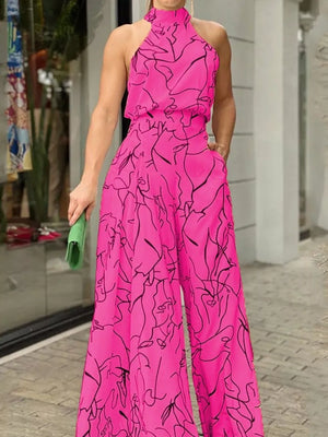 Hot Pink abstract print halter neck wide leg romper with pockets.