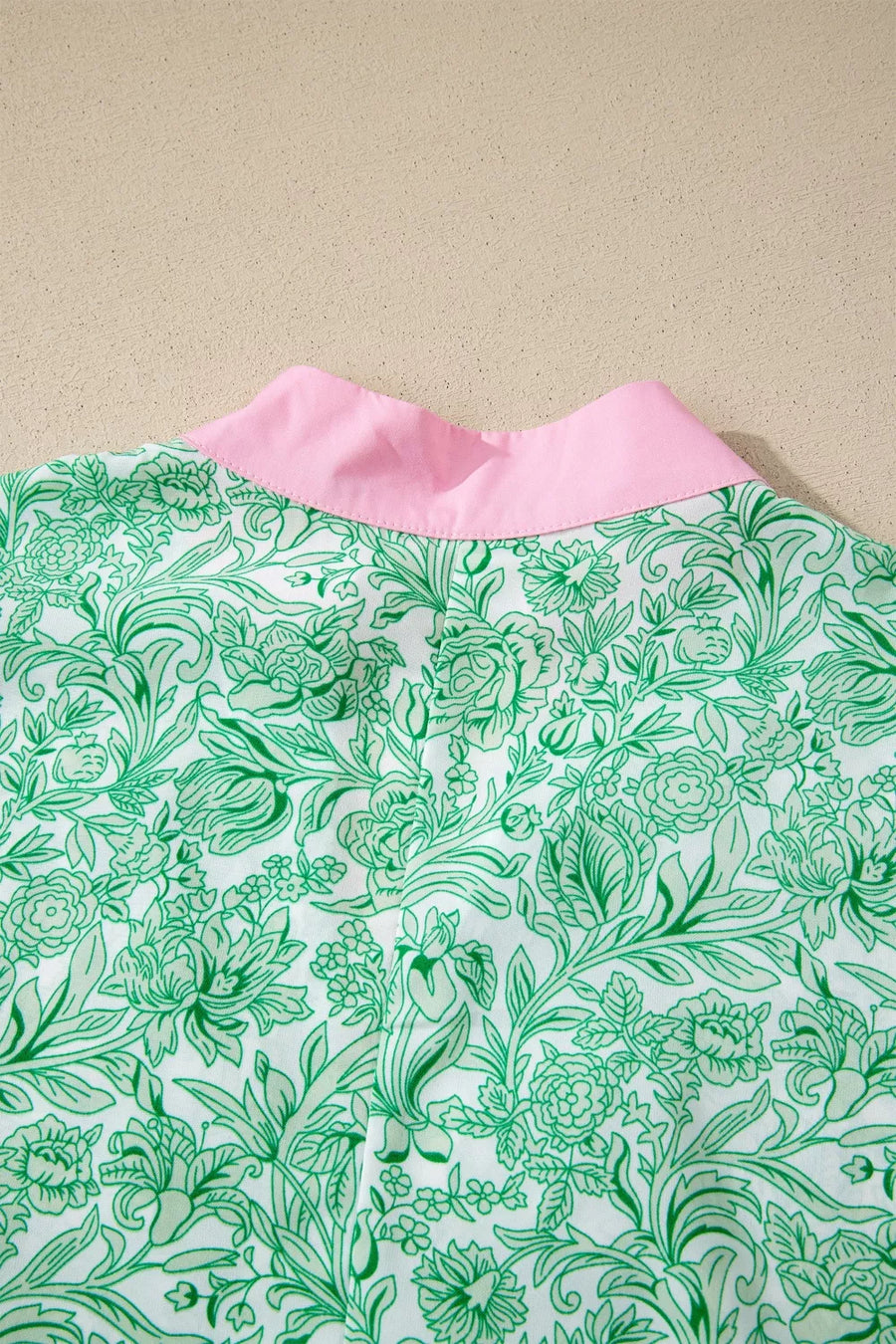 Botanical print midi dress with pink collar and flutter sleeves.