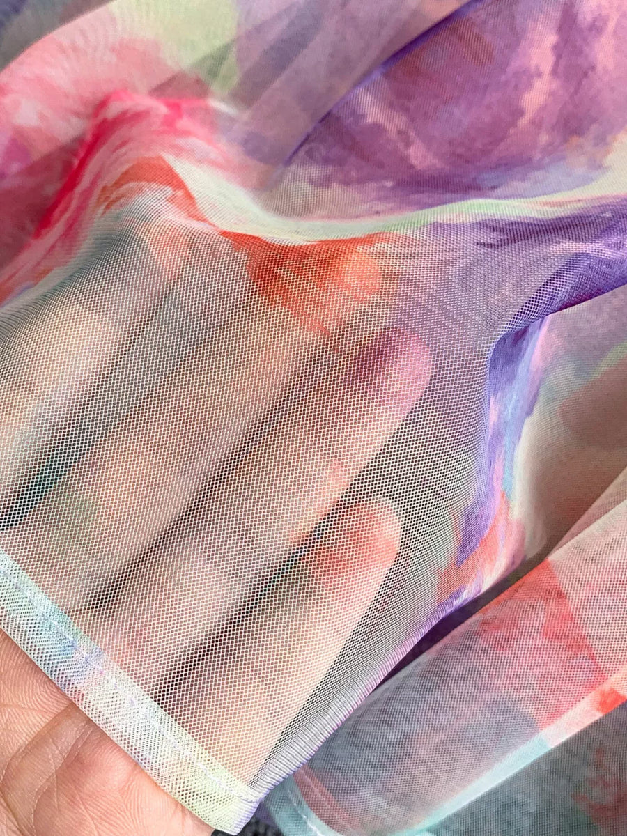 Floral midi dress fabric in watercolor sherbet, purple, and pink hues with a sheer mesh texture.
