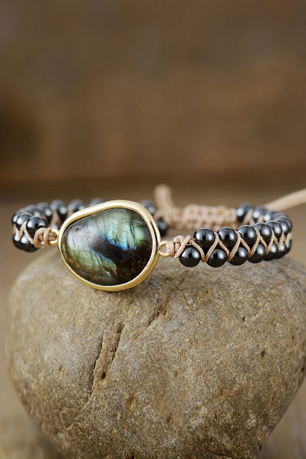 Black beaded bracelet with labradorite stone and braided cord detail.
