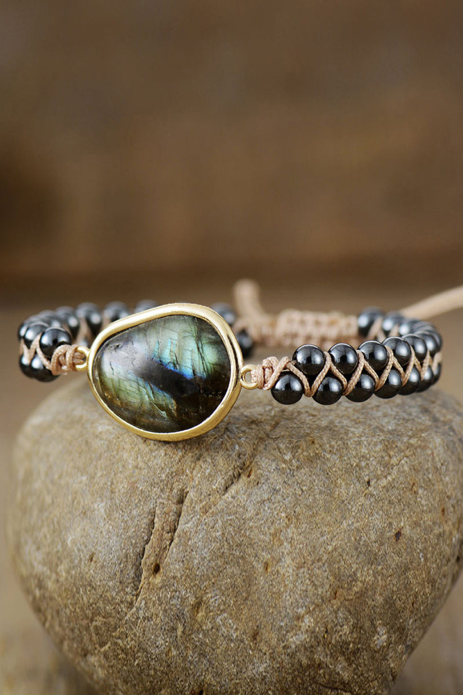 Black beaded bracelet with labradorite stone and braided cord detail.