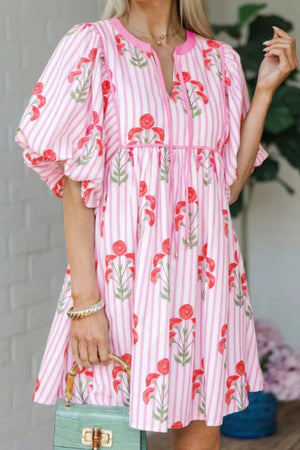 Floral stripe mini dress in blush pink with red floral print, puff sleeves, and tie detail.