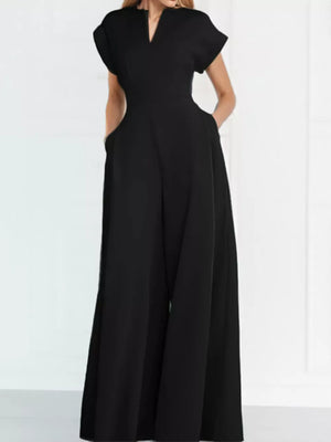 Black wide-leg romper with V-neck, short sleeves, and pockets.
