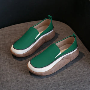 Turquoise slip-on platform sneakers with white and brown layered soles.