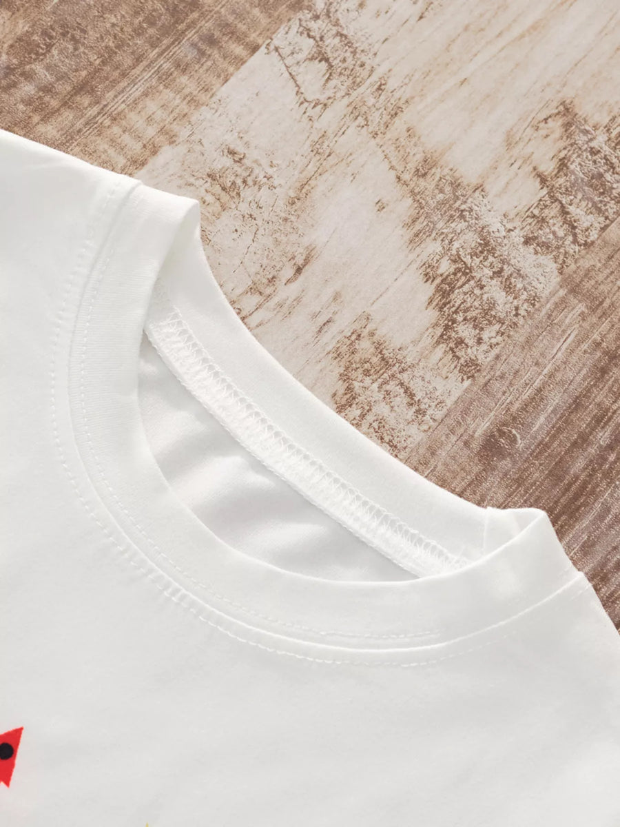 White children's long-sleeve pajama top with a round neckline and tree print detail.