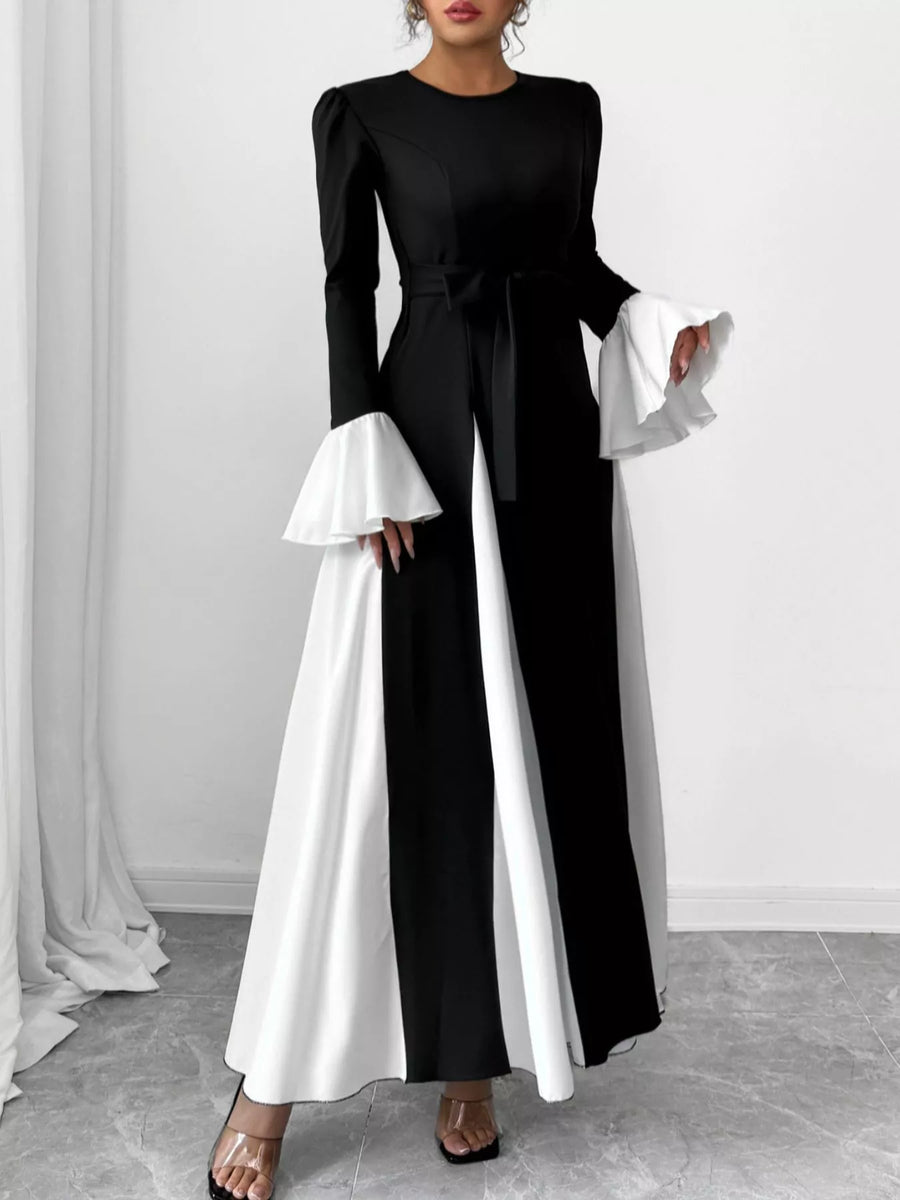 Black maxi dress with tie waist and white flare sleeves.