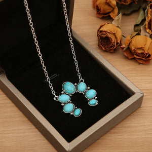 Turquoise horseshoe necklace with silver chain and alloy setting.