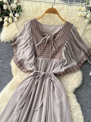 Embroidered V-neck maxi dress in Khaki Color with tie detail and flutter sleeves.