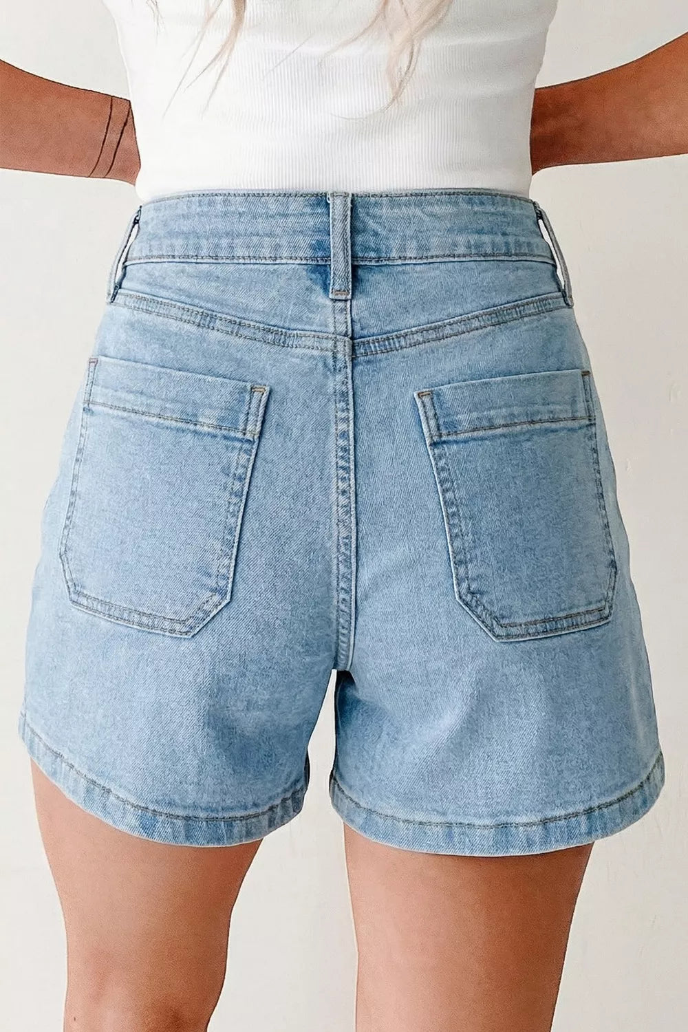 Light wash denim shorts with high rise and patch pockets.