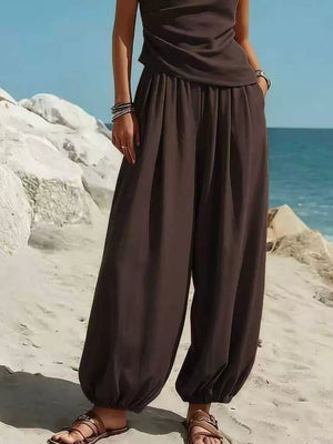 Brown one-shoulder top and wide-leg pants set with elastic waist and pockets.