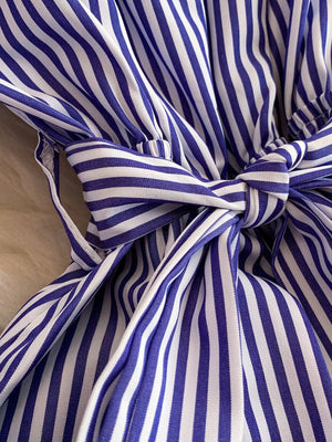 Blue and white striped belted romper with a bow detail