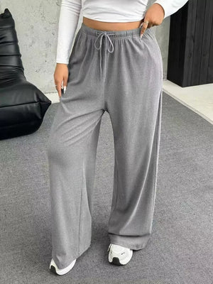 Maternity wide-leg pants in light gray with drawstring waist and relaxed fit.