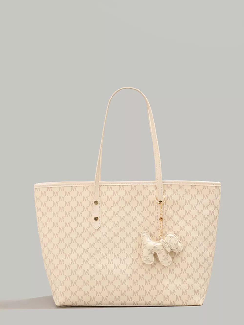 Ivory monogrammed tote bag with dog charm accessory