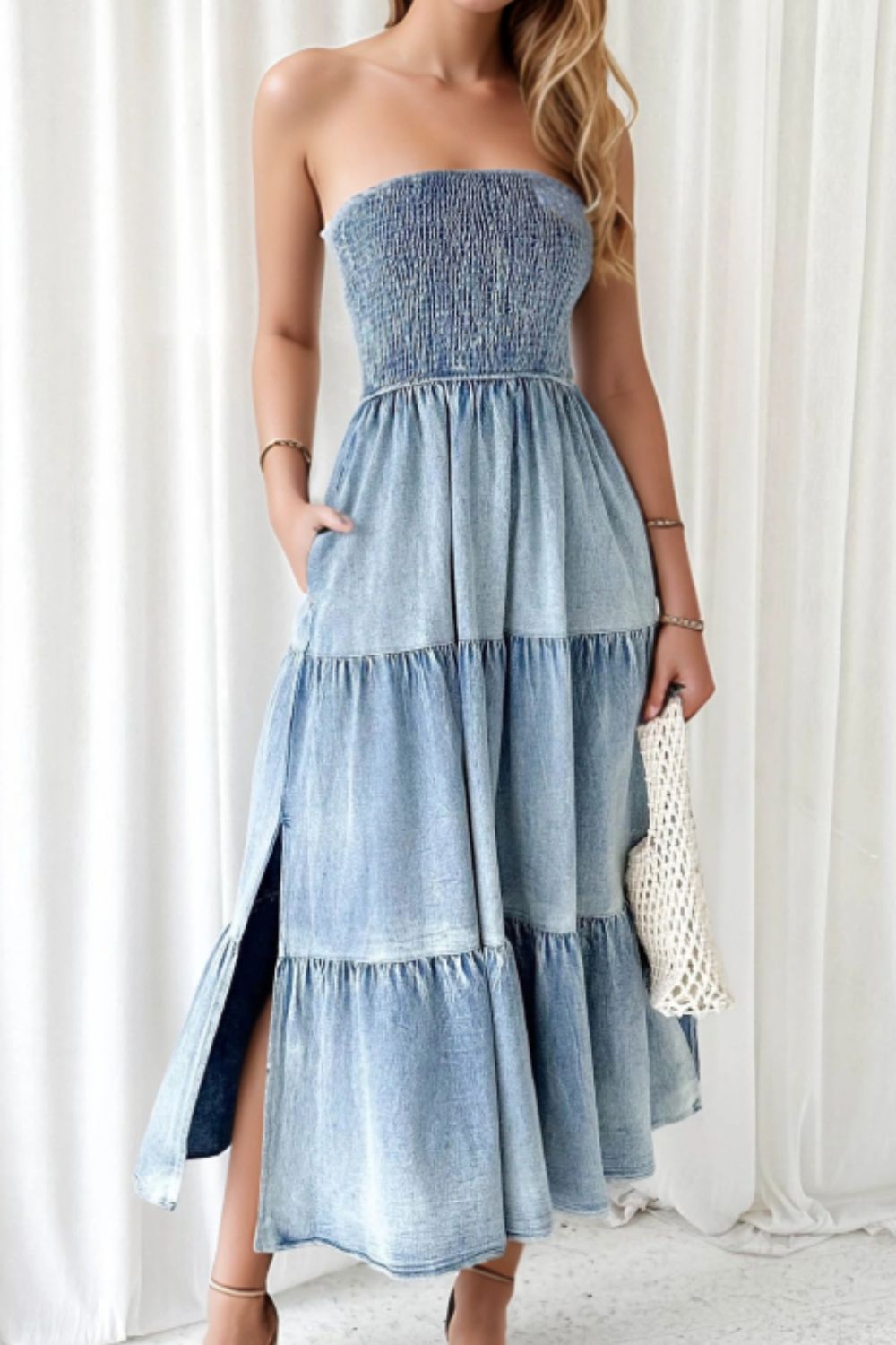 Light blue denim strapless tiered maxi dress with smocked bodice and side slits.