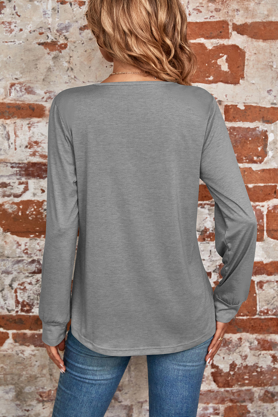 Gray long sleeve top with a square neckline and subtle pleating detail at the back.